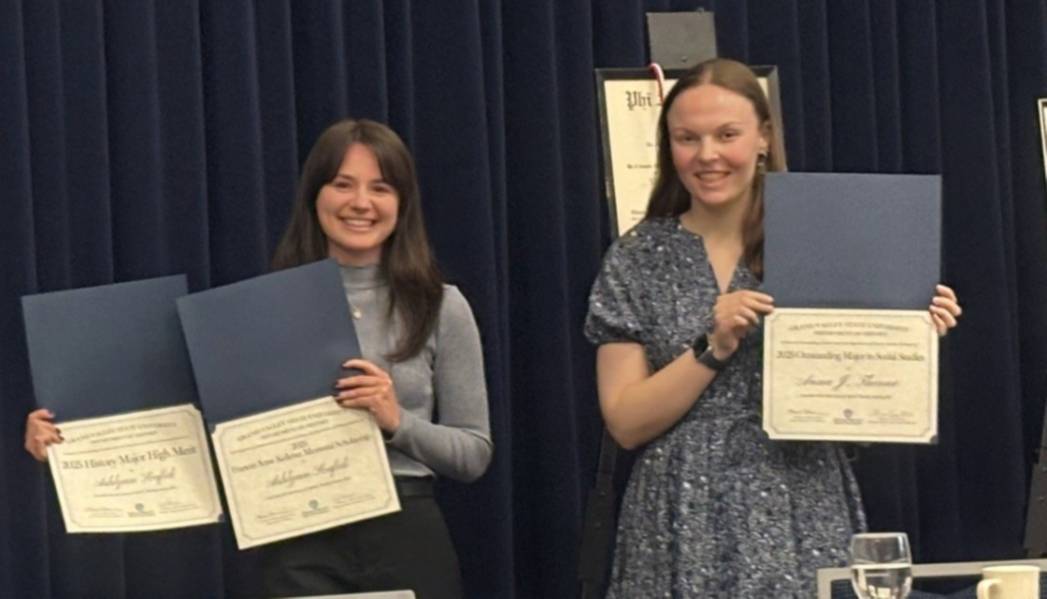 Two student winners accepting awards